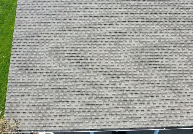Overhead detail of a shingled roof and gutter